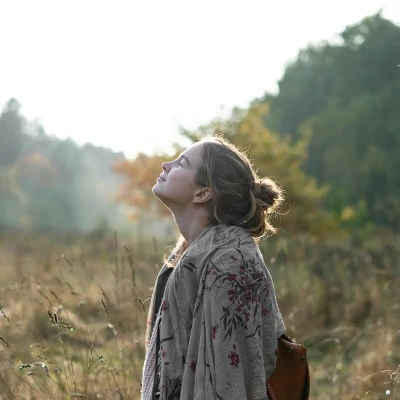 A woman under bright sunlight, looking up