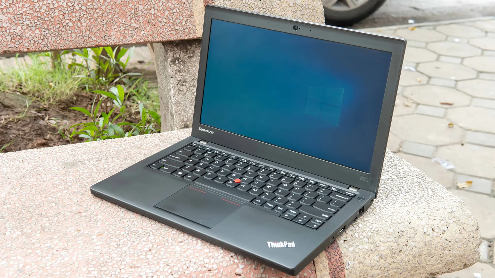 A Lenovo X240 on a bench as an example of ideal gear for travel